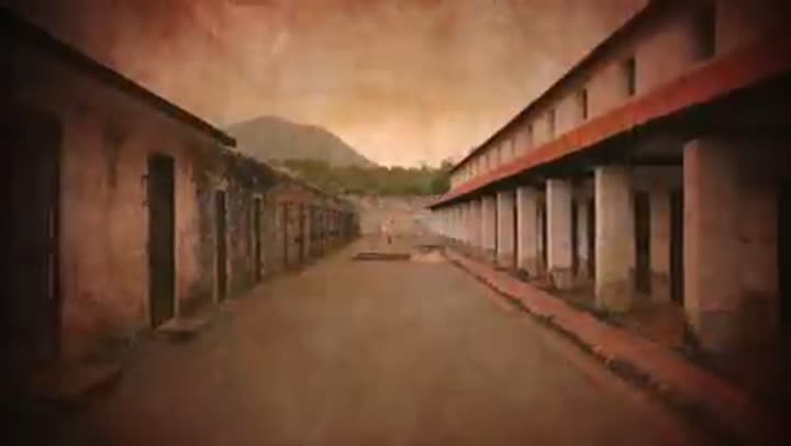 The stark, oppressive corridors of the "Tiger Cages" prison, a symbol of cruelty.