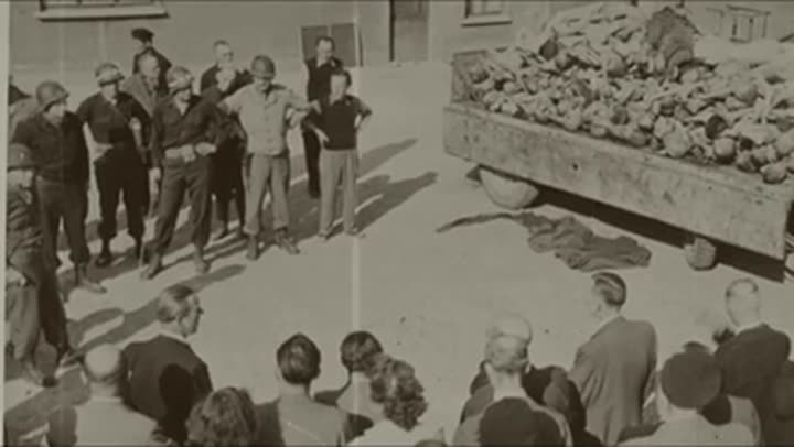 Allied soldiers and civilians witness the horrific aftermath of Nazi atrocities.